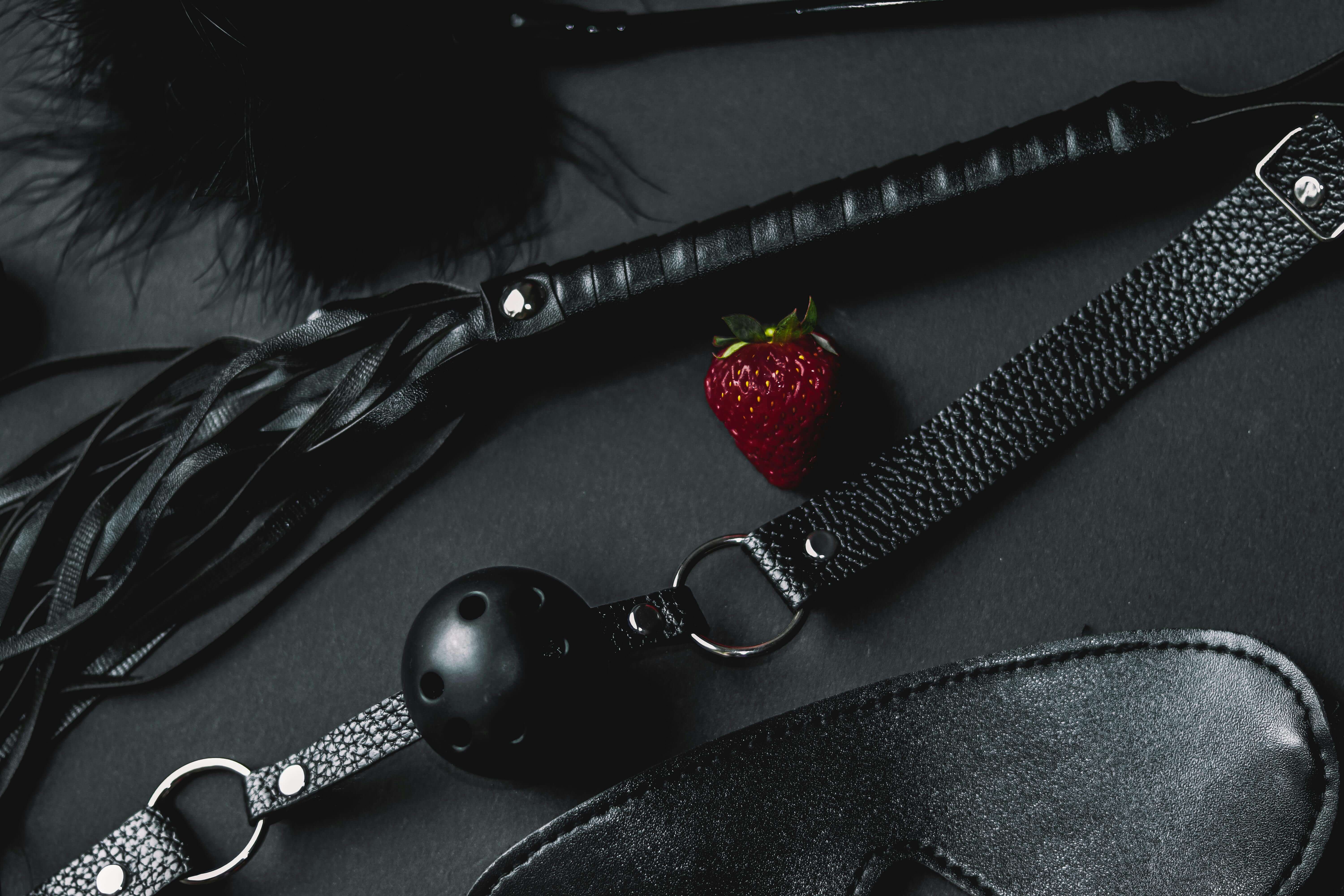 BDSM equiptment including a ball gag and leather whip