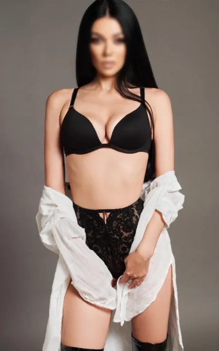 Elena standing in a white shirt and black lingerie 