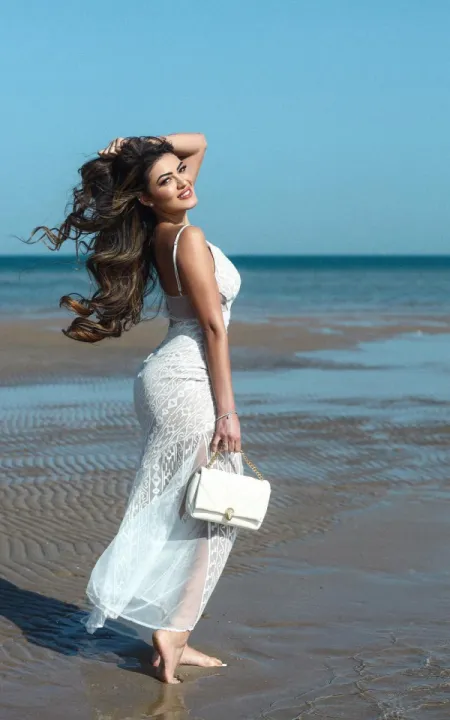 Luana on the beach in a lavish white dress 