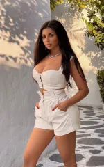 Samantha posing with a white outfit. 