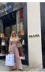 Sophie outside a prada store in a tan dress 