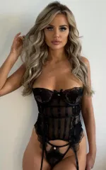 Rebecca wearing a set of black lingerie and corset. 