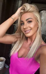 Alice taking a selfie in a pink top 