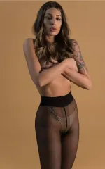 Rochelle hiding her naked breasts by holding them while standing in tights 