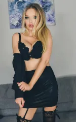 Joanna Bujoli taking off her top to reveal her black bra and skirt 