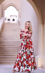 Joanna Bujoli standing infront of some stairs while wearing a large summer dress 