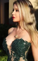 Joanna Bujoli wearing an exotic green dress that is green and glittery 