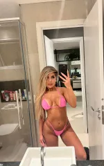 Nicole taking a selfie in the bathroom in pink lingerie 