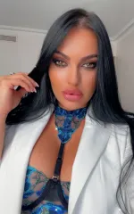 Honey Demon taking a selfie while wearing a dark blue bra and white blazer 