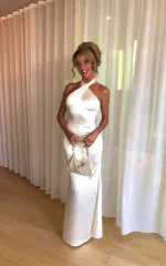 Gracie standing in a white dress 