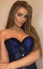 Rebecca posing in a dark blue corset 