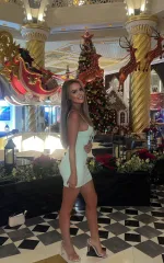 Rebecca standing in a white dress while enjoying a christmas showcase 