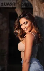 Luana smiling at you in a corset 