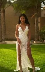 Melanie standing in a long, pretty white dress