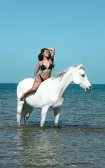 Luana sitting on a white horse 