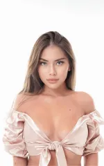 Gala looking at you while wearing a silver tied shirt 