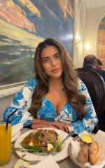 Gala enjoying a gourmet meal while wearing a blue and white top 
