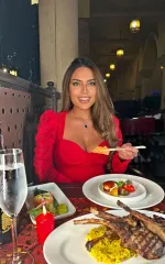 Gala wearing a red dress while out for a meal 