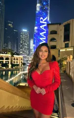 Gala standing in a red dress 