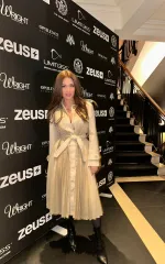 Gianna wearing a beige coat while on the red carpet 