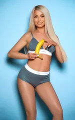 Ada holding a banana while smiling at you in calvin klein underwear 